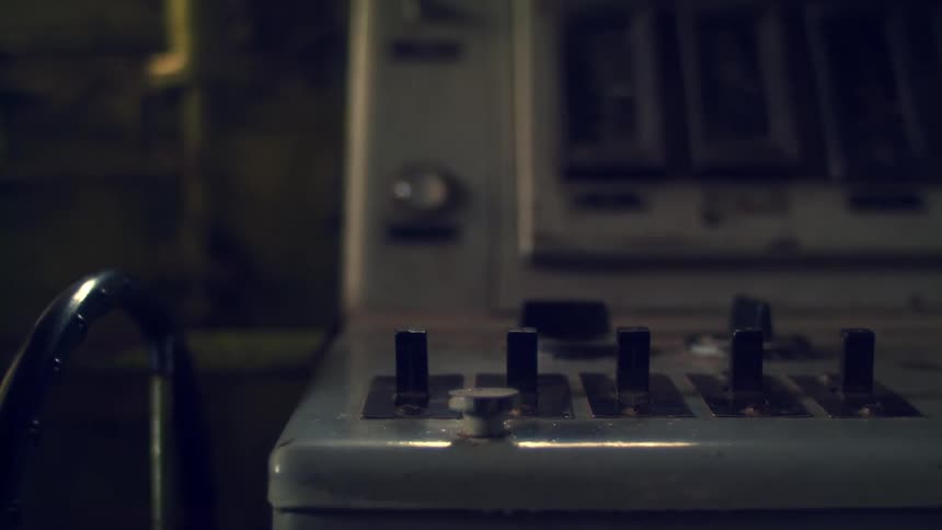 Old control panel with buttons and levers on an industrial machine