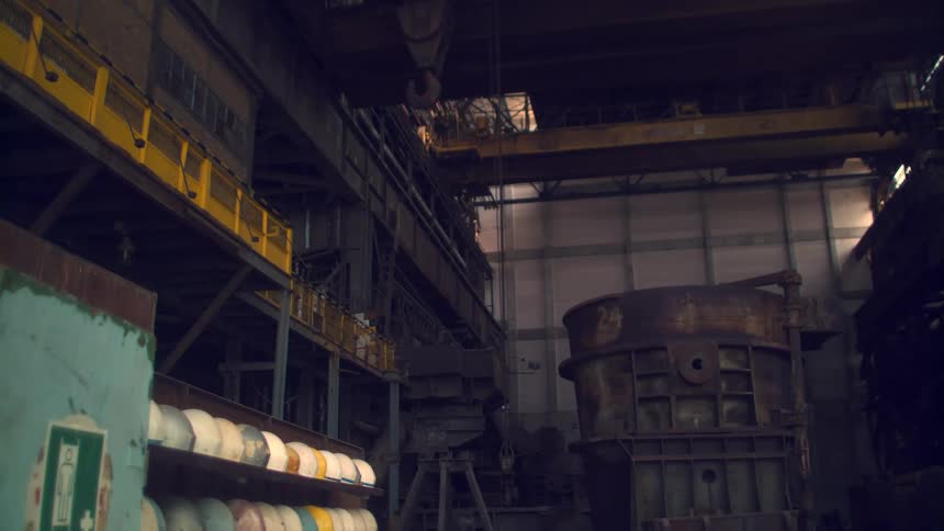 An old factory building has rusted and well used equipment