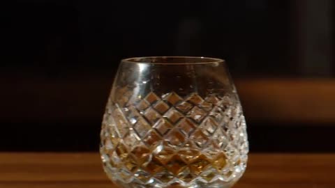 Cut crystal glass with drink on a wooden table