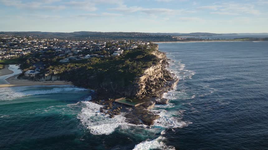 A large city is built on the coast including on a rocky peninsula