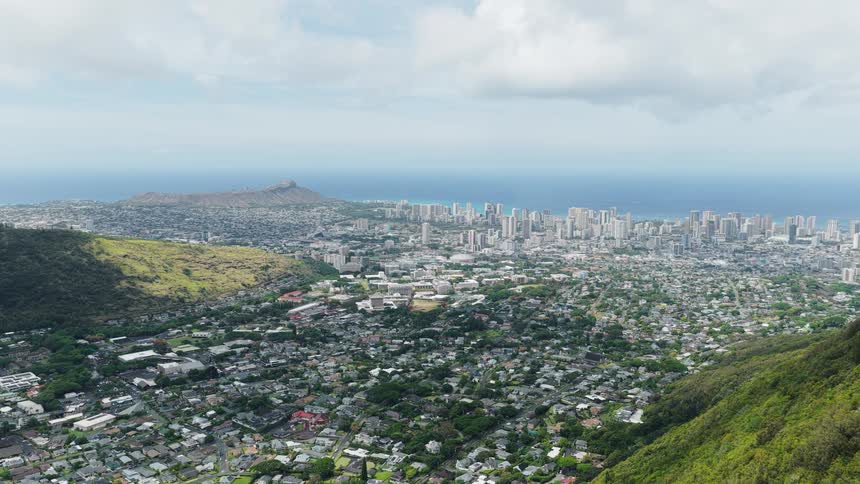 A sprawling city is build between to mountain peaks on the coast