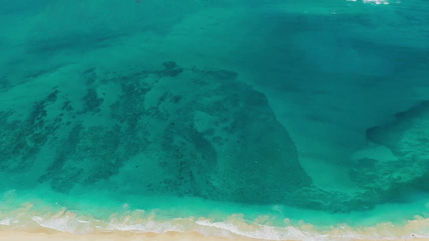 Crystalclear blue sea with different shades of water stretching to the horizon