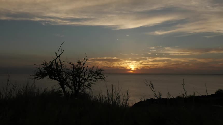 The sun sets on the shore