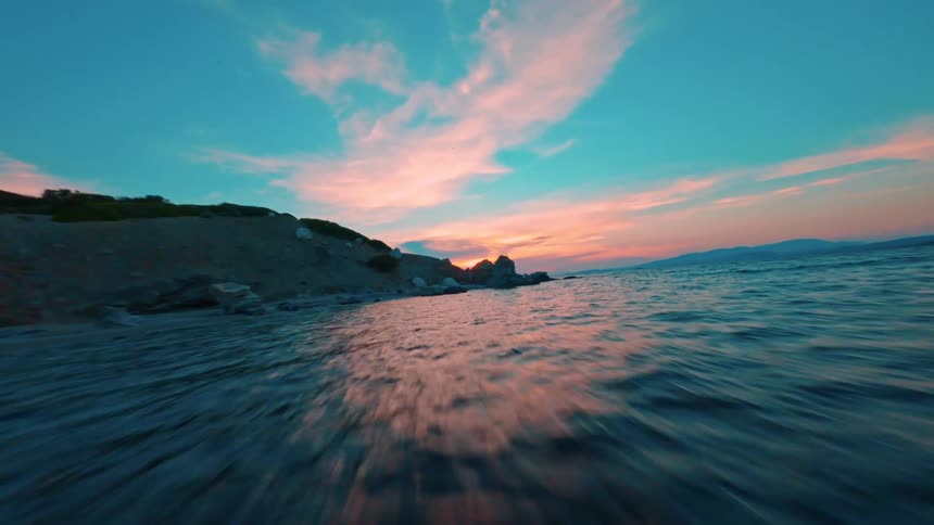 The waves hit the shore of the small island
