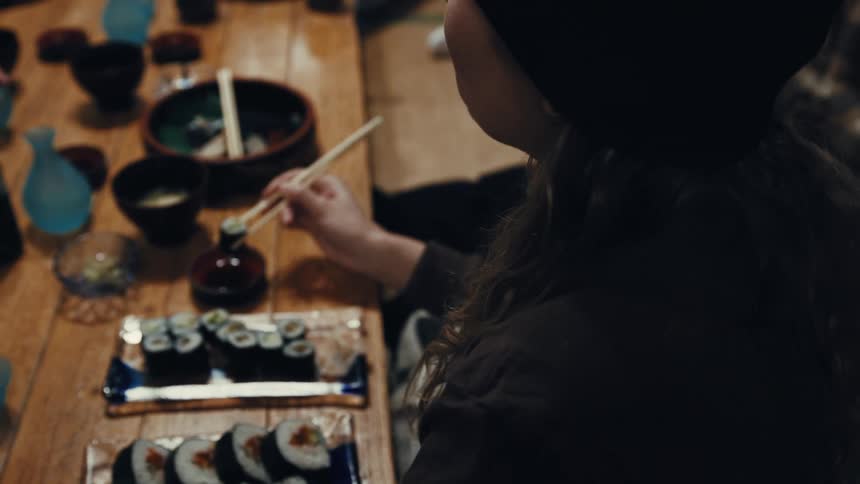 People are eating sushi together in the restaurant