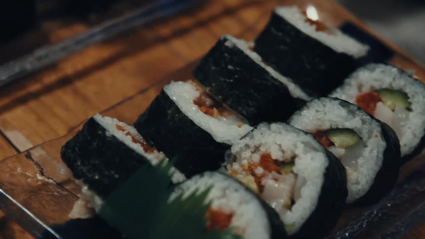Closeup of sushi rolls on a wooden tray
