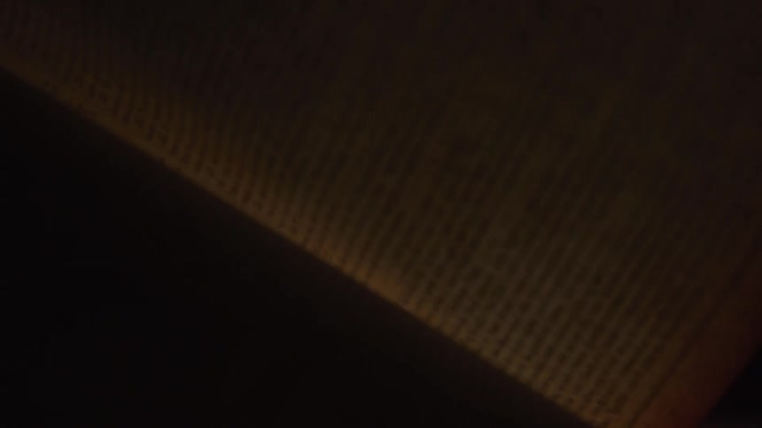 Book page being flipped under soft lighting