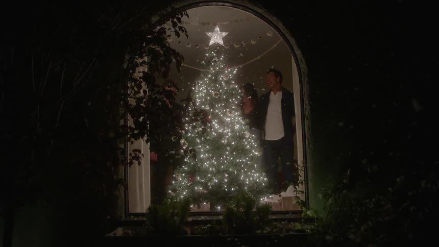 Friends singing and celebrating christmas in a cozy living room