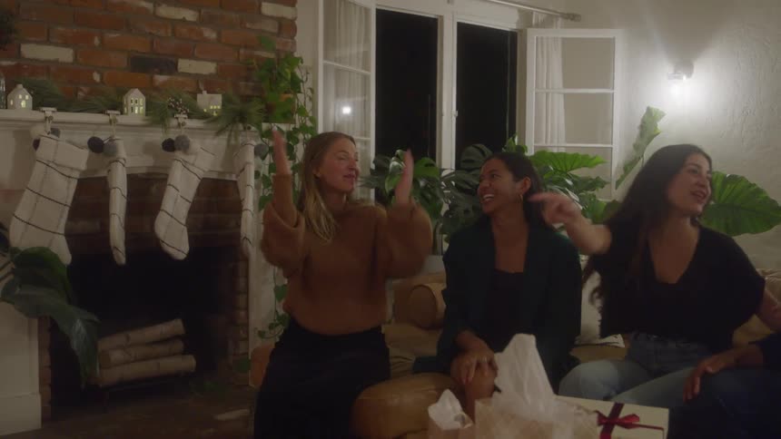 Friends laugh and enjoying time together in a cozy living room