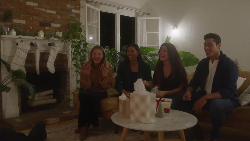 A group of adult friends in a living room playing charades