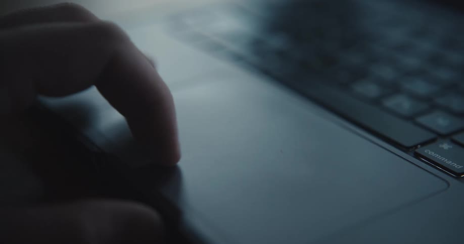Person uses the touchpad to navigate on a laptop