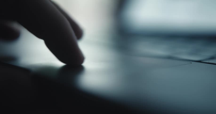 Person manipulates a laptop computer using the touchpad