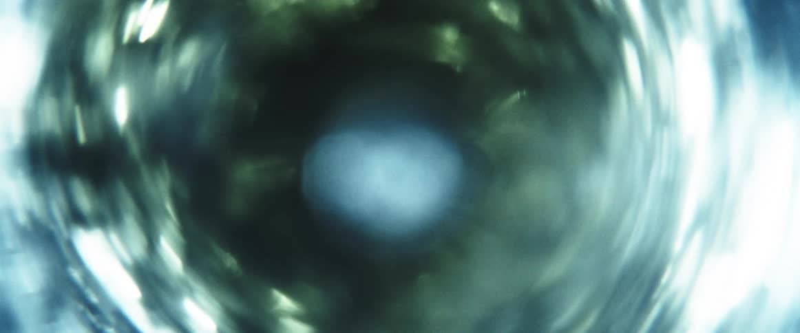 A liquid with multiple suspended bubbles rotates rapidly