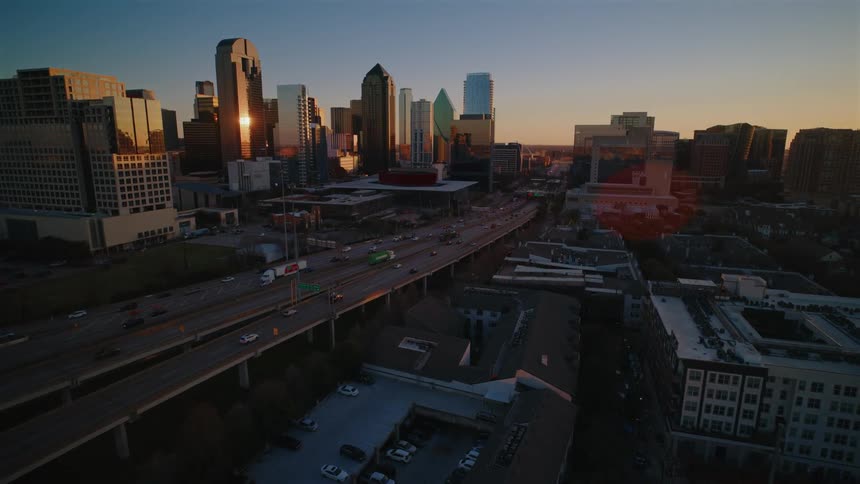 Aerial view of a modern city skyline at sunset
