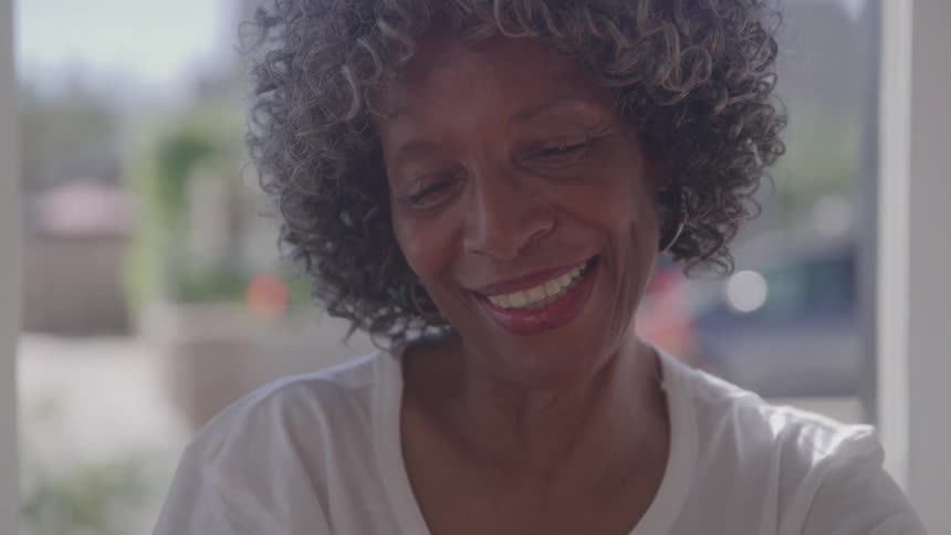 The elderly woman is smiling