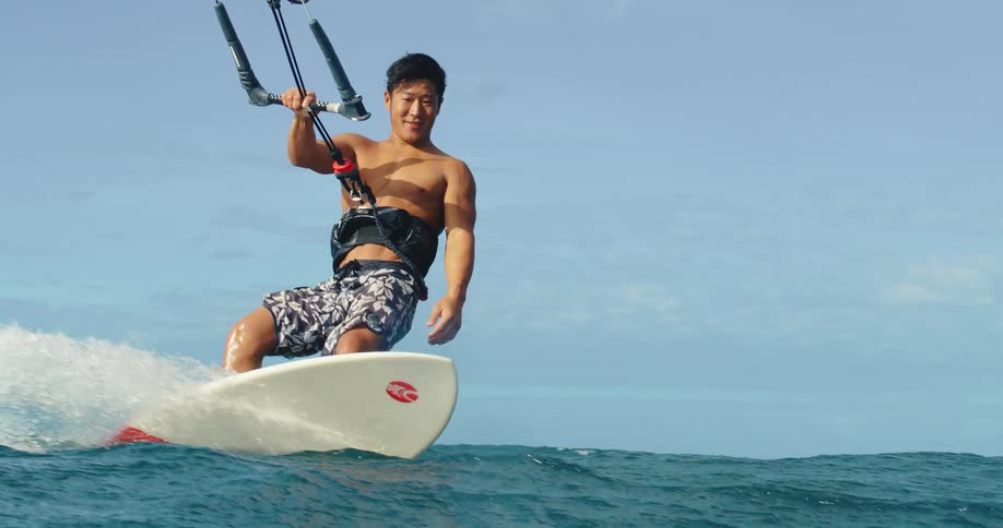 A happy man practicing kitesurfing