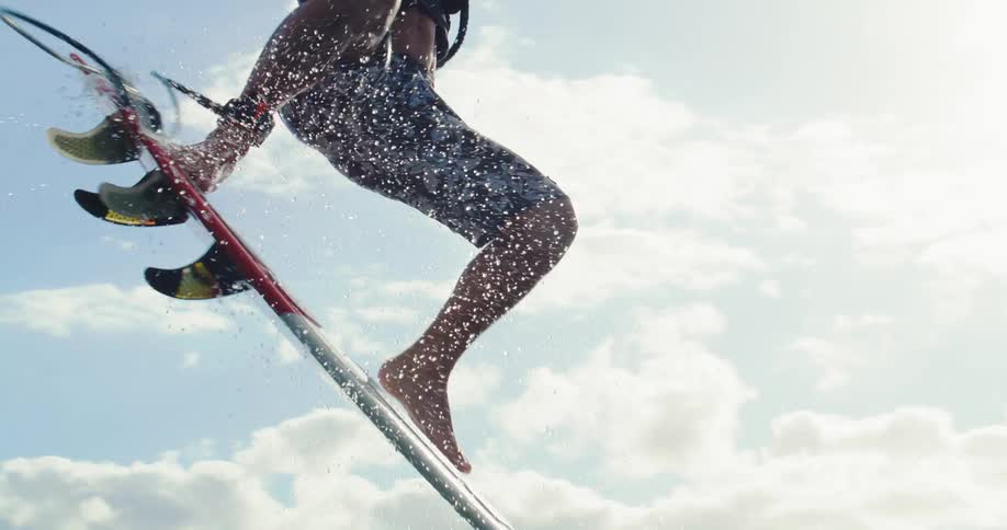 Man practicing kitesurfing on the ocean waves