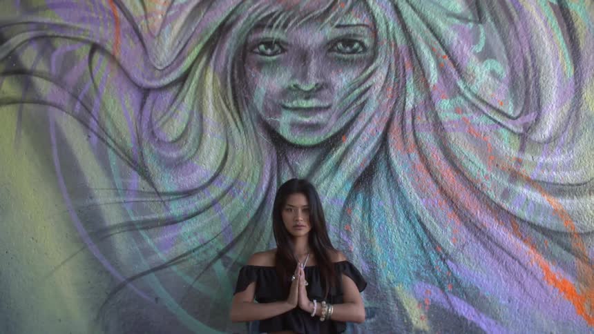 Woman standing in front of artwork
