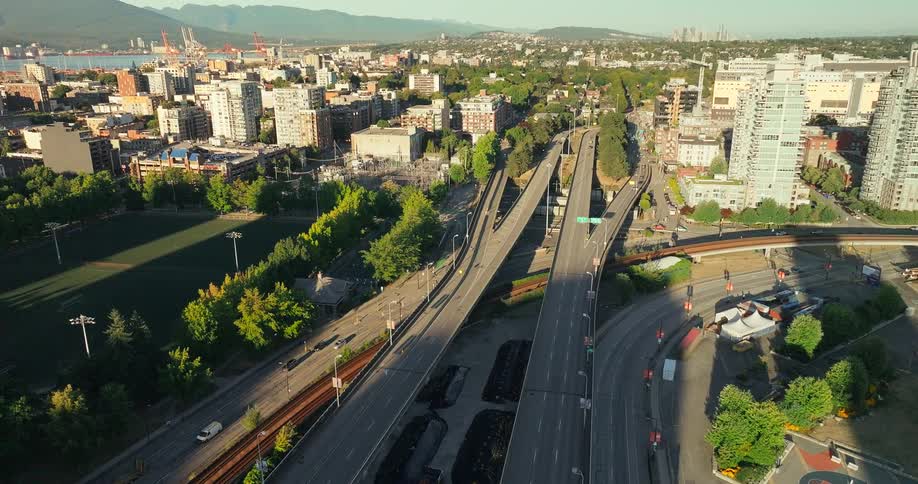 Overpasses and busy avenues surrounded by buildings and green areas