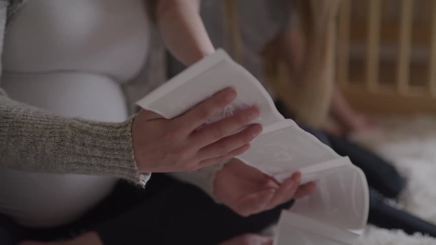 A mother is showing her daughter the ultrasound printout