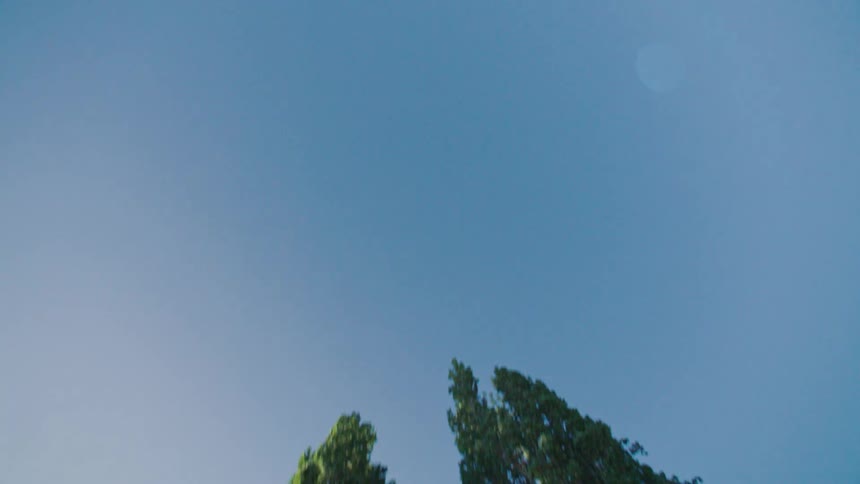A plastic sheet floats in the clear sky