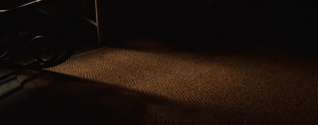 The room is dark and full of shadows