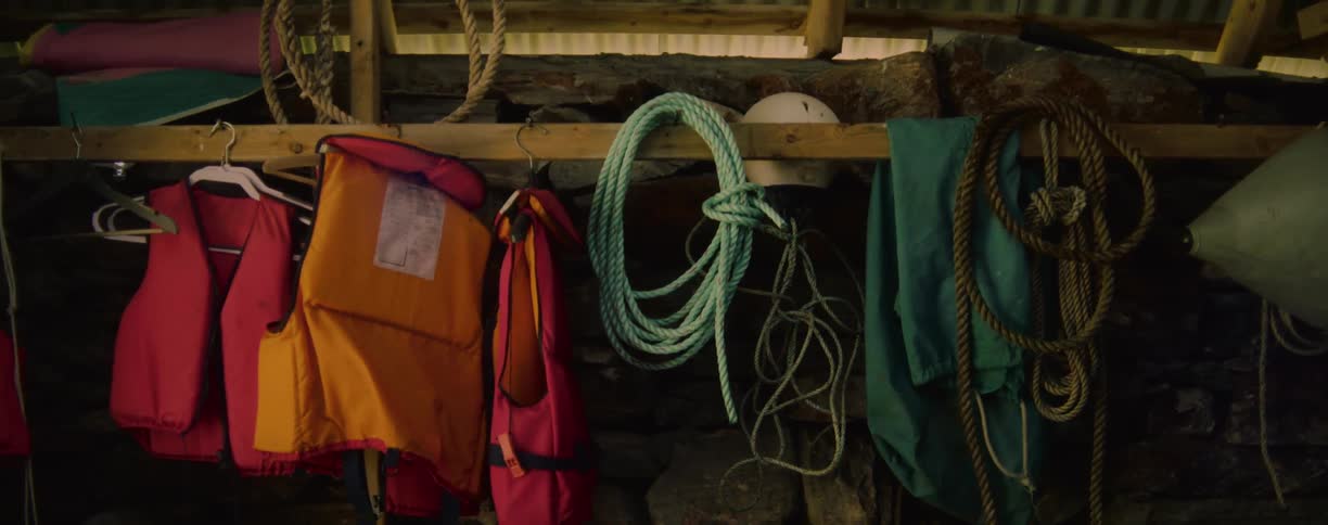 Ropes and life vests hang on the hooks