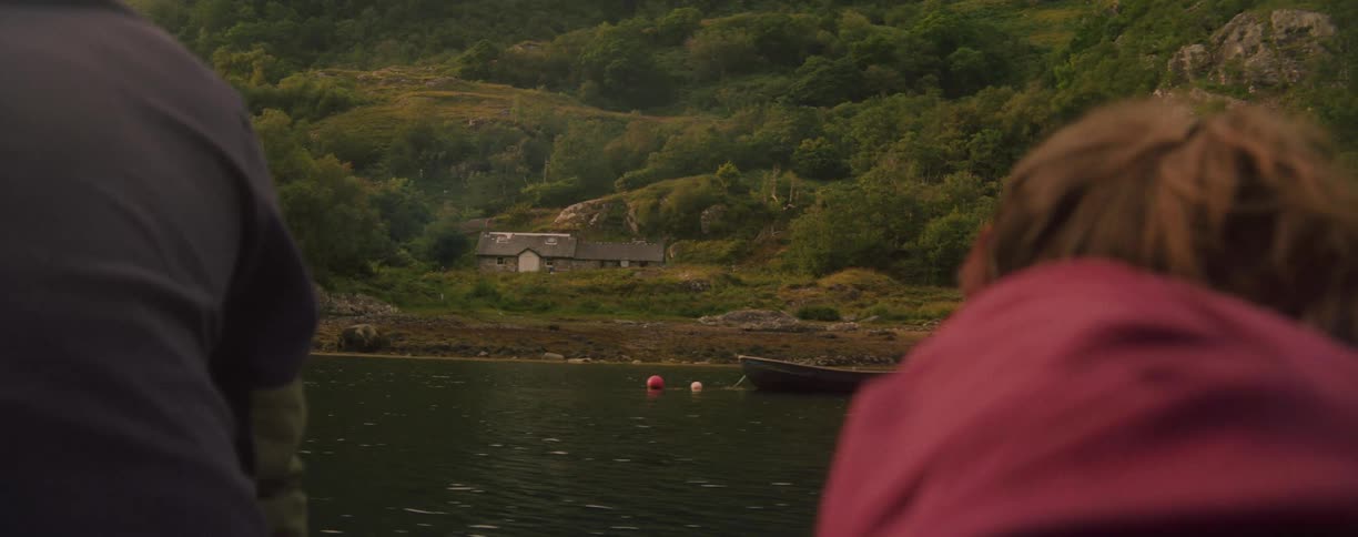 Two people are riding on a boat in the river