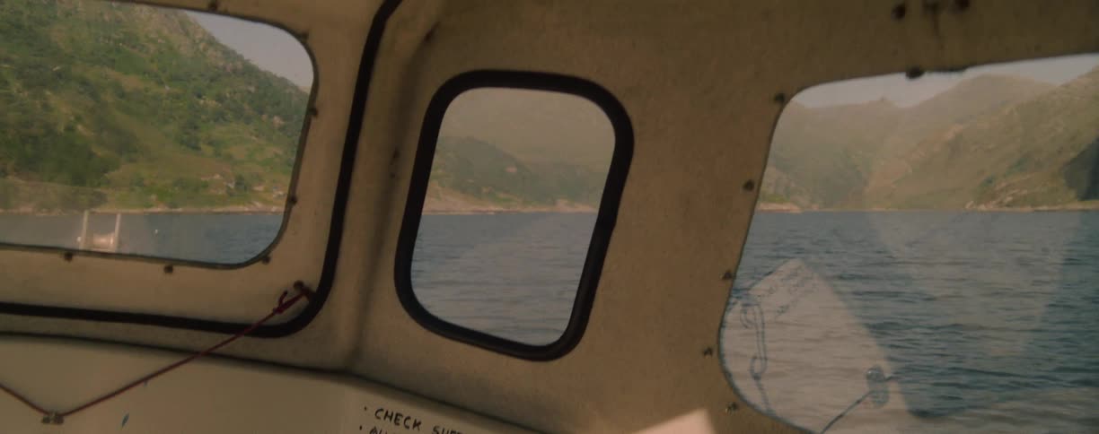 The boat is traveling across the lake water
