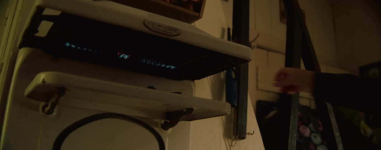 A woman lights the pilot on the machine
