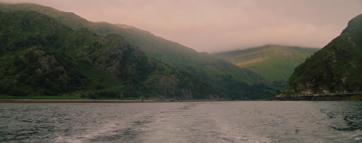 River flows in the mountain valley under a cloudy sky