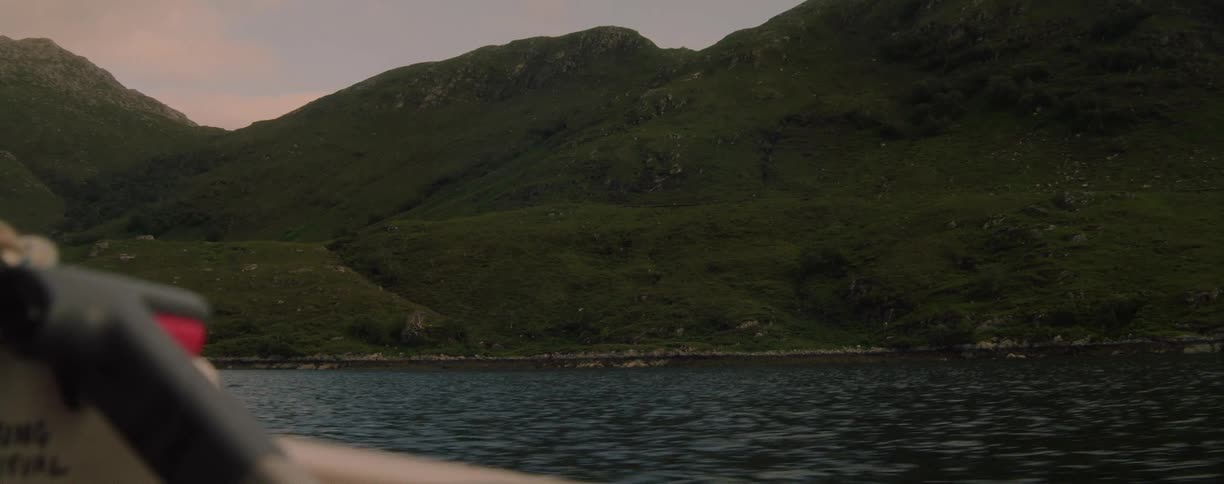 View of a mountainous landscape from a moving boat