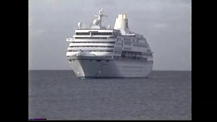 A large cruise ship sails on the open sea