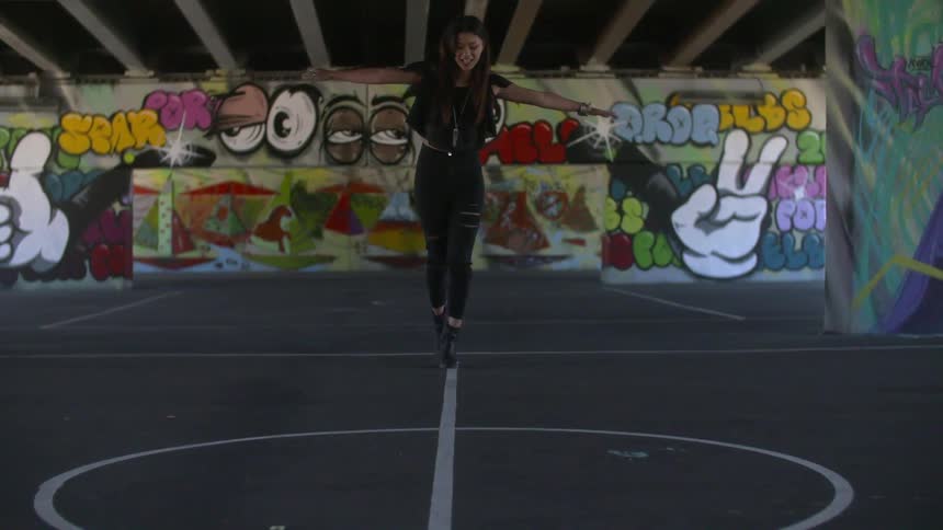 Girl walking across a thin white line on the floor