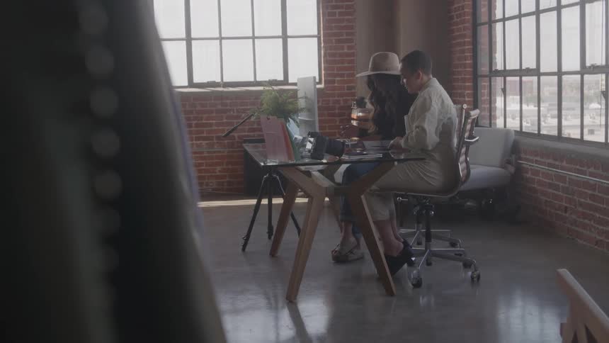 Two people working at a desk in a modern office