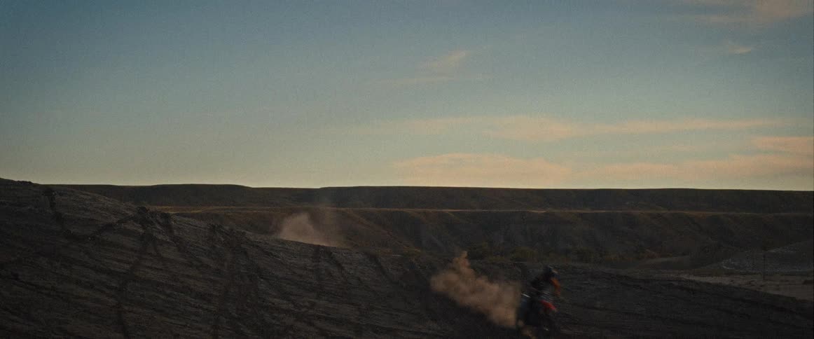 A person making a big jump on a motorcycle in a motocross race