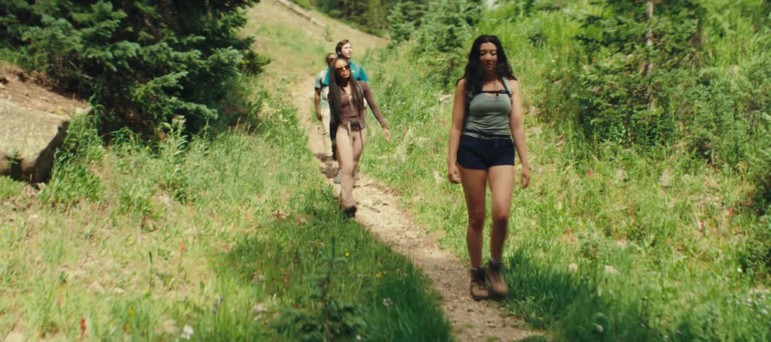 Group of friends are hiking on a forest trail