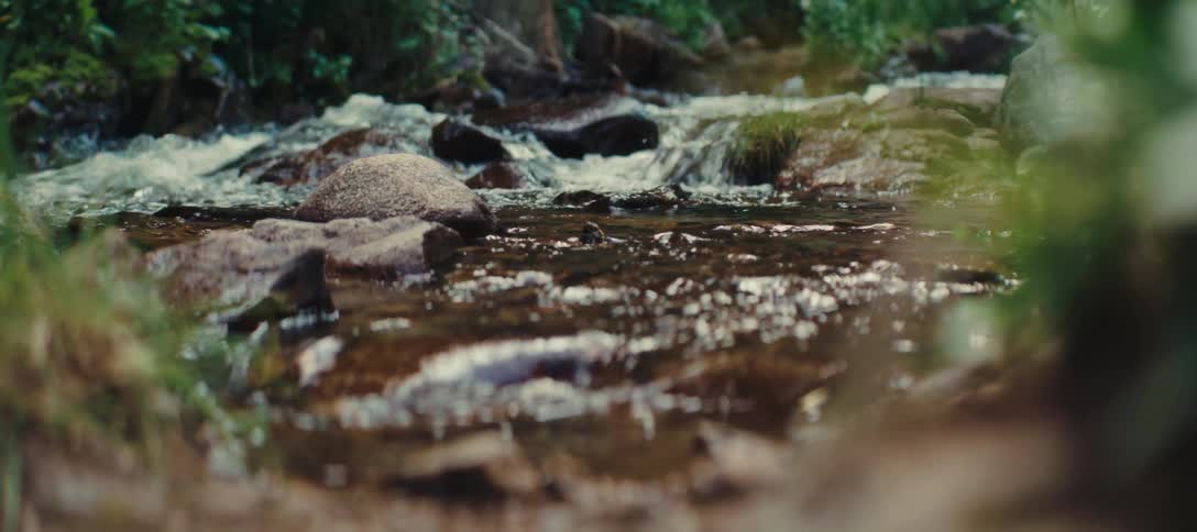 Close up of a small stream flowing over river rocks