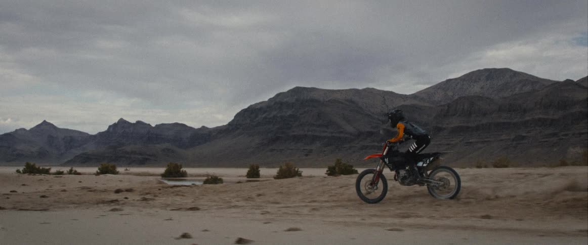 The motocross driver goes up the sand hill