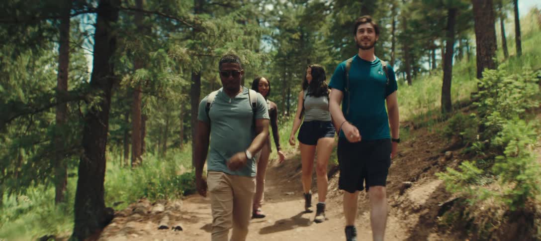 Friends are hiking together on a forest trail