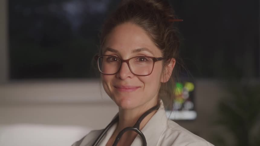 A female medical professional turns her head and smiles