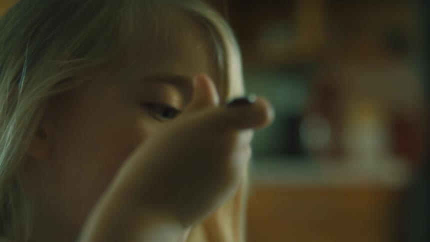Closeup shot of a young child eating with a spoon