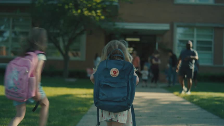 The girl is heading to the school