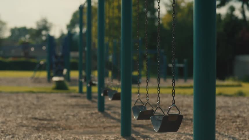 The swings are empty in the playground