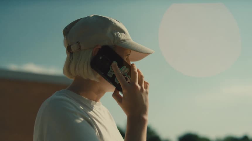 The woman answers her cell phone outside