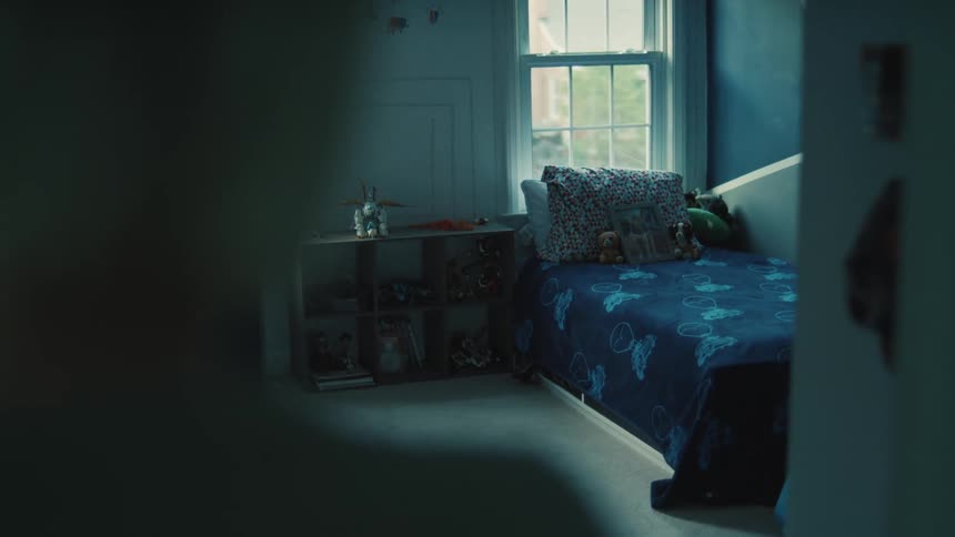 The woman looks in the empty bedroom