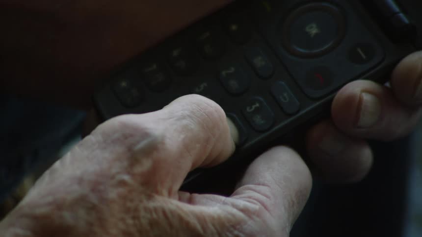 A man dials on his cell phone