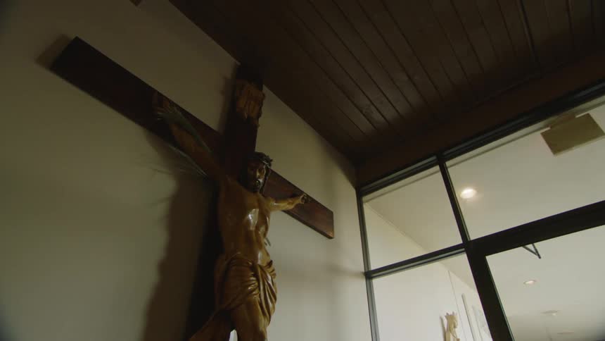 A large cross is on the wall of the church