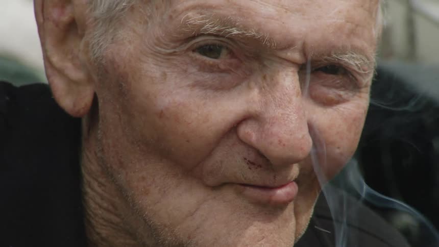 Close up of an elderly man smoking a cigarette