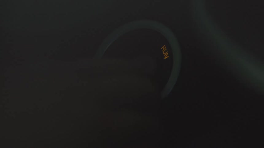 Vehicle ignition button being pressed